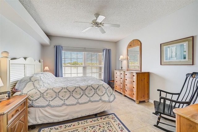 tiled bedroom with a textured ceiling and ceiling fan