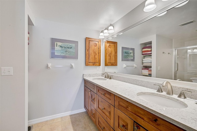 bathroom with tile flooring, vanity with extensive cabinet space, and dual sinks