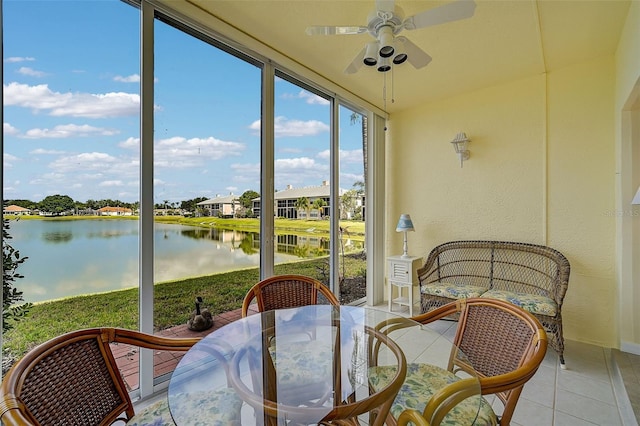 sunroom with a water view and ceiling fan