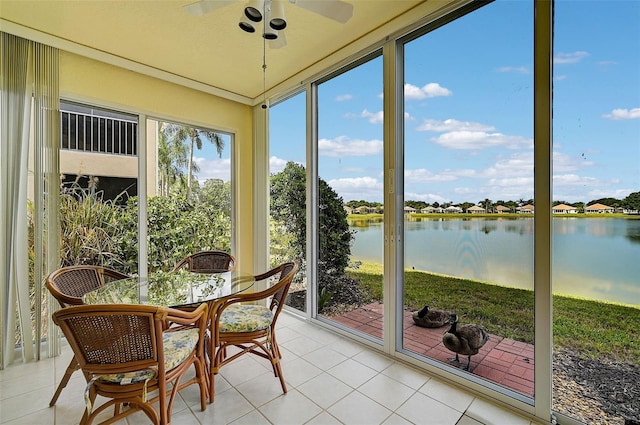 sunroom / solarium with a water view and ceiling fan