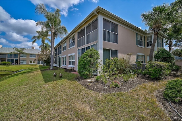 view of side of home with a lawn