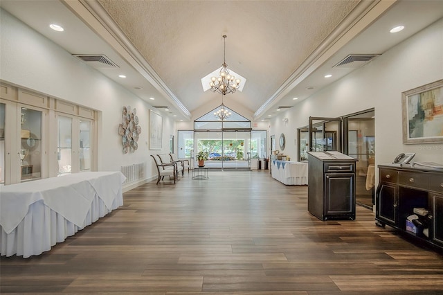 interior space featuring french doors, a notable chandelier, dark hardwood / wood-style flooring, a textured ceiling, and high vaulted ceiling