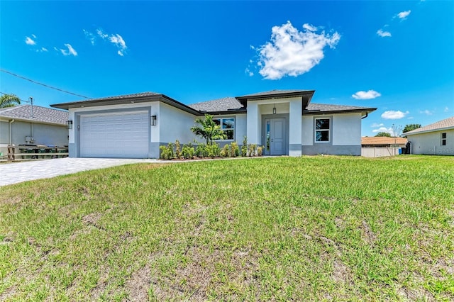 view of front of house featuring a garage and a front lawn