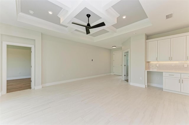 spare room featuring coffered ceiling, light hardwood / wood-style floors, ceiling fan, and a raised ceiling