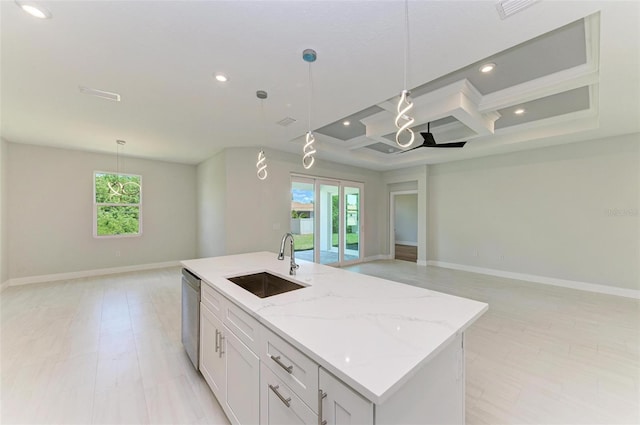 kitchen featuring a center island with sink, pendant lighting, and coffered ceiling