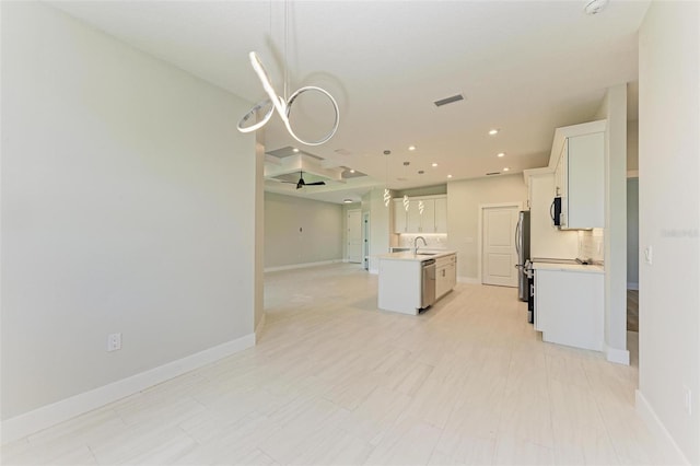 kitchen with stainless steel appliances, a kitchen island with sink, white cabinets, and light tile flooring