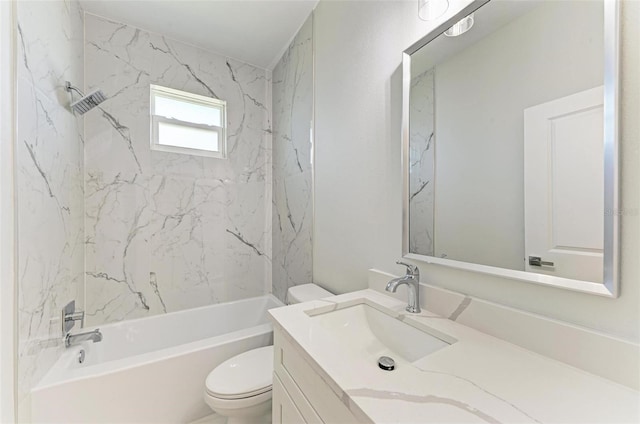 full bathroom with vanity, tiled shower / bath combo, and toilet