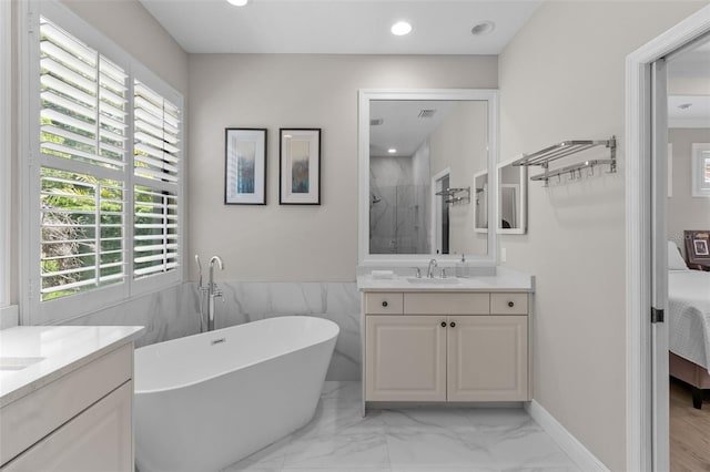 bathroom with a wealth of natural light, vanity, shower with separate bathtub, and tile walls