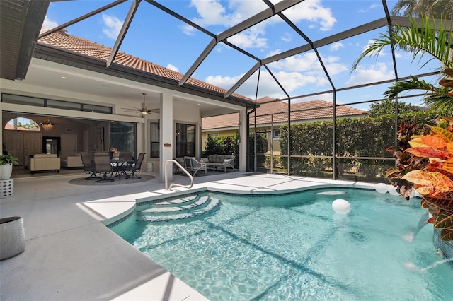 view of swimming pool featuring an outdoor hangout area, pool water feature, ceiling fan, a lanai, and a patio area