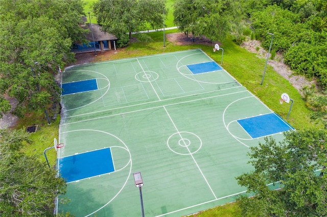 view of sport court featuring a lawn