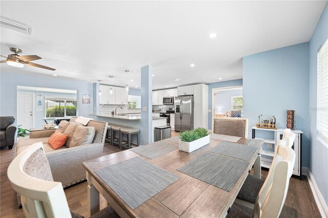 dining space with dark wood-style floors, baseboards, a ceiling fan, and recessed lighting