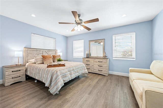 bedroom with recessed lighting, ceiling fan, baseboards, and wood finished floors