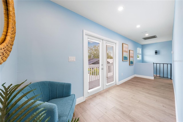 doorway to outside featuring french doors, visible vents, light wood-style flooring, and baseboards