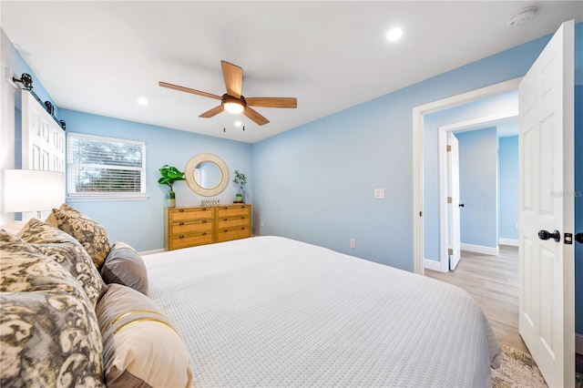 bedroom with ceiling fan, recessed lighting, baseboards, and light wood-style floors