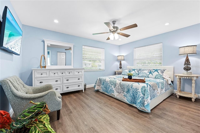 bedroom with a ceiling fan, recessed lighting, baseboards, and wood finished floors