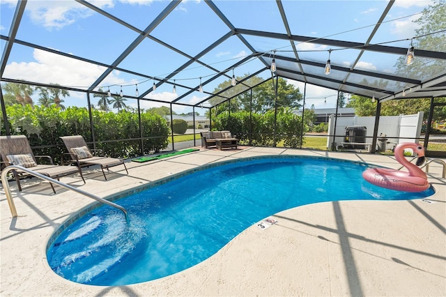 view of swimming pool with a patio, a lanai, and a fenced in pool