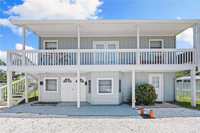 view of front of home with stairs and board and batten siding