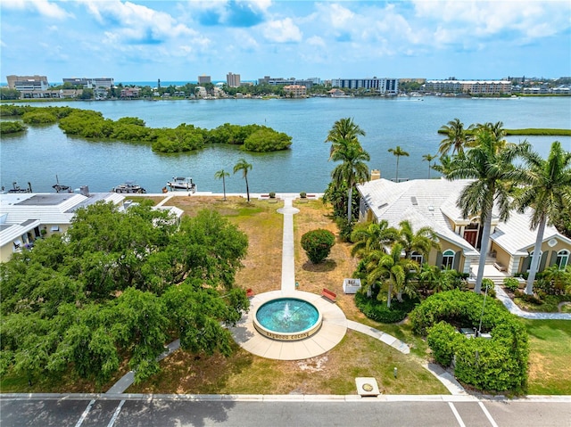 birds eye view of property with a water view and a city view