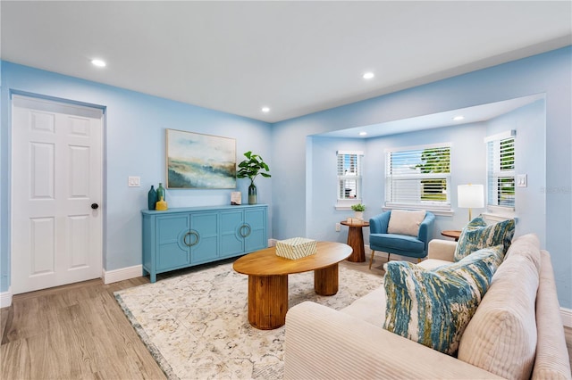 living room with recessed lighting, baseboards, and light wood finished floors