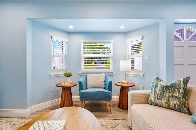 living area with recessed lighting, wood finished floors, and baseboards