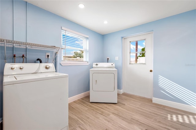 laundry area with light wood-type flooring, laundry area, plenty of natural light, and independent washer and dryer