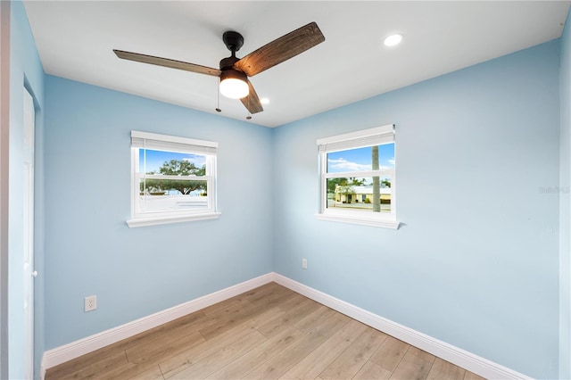 unfurnished room featuring light wood-style floors, a wealth of natural light, baseboards, and recessed lighting