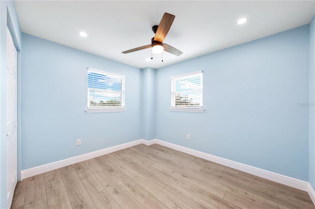 spare room featuring recessed lighting, ceiling fan, light wood-style flooring, and baseboards