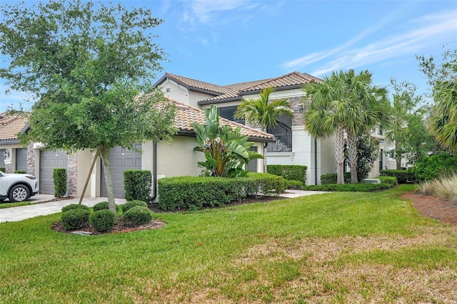 mediterranean / spanish-style home featuring a front yard and a garage