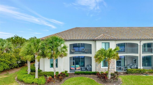 back of property with a balcony