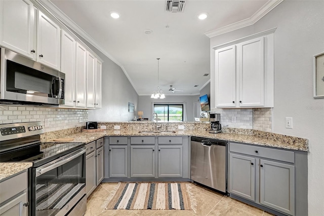 kitchen with kitchen peninsula, appliances with stainless steel finishes, backsplash, light tile flooring, and sink