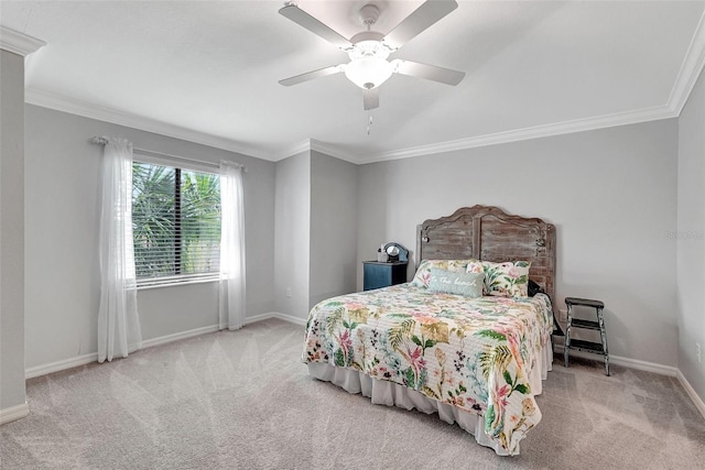 carpeted bedroom featuring ceiling fan and crown molding