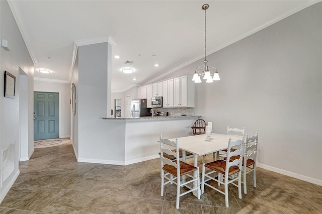 dining space with lofted ceiling, a chandelier, light tile floors, and ornamental molding