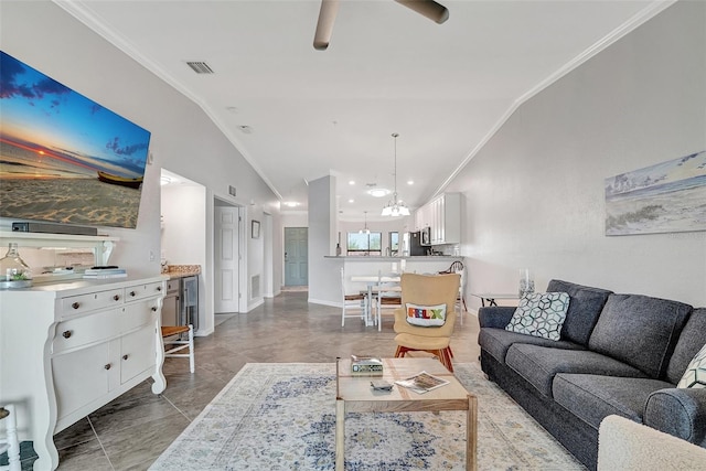 tiled living room featuring ceiling fan with notable chandelier, lofted ceiling, wine cooler, and ornamental molding