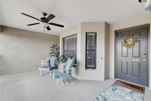 doorway to property with ceiling fan