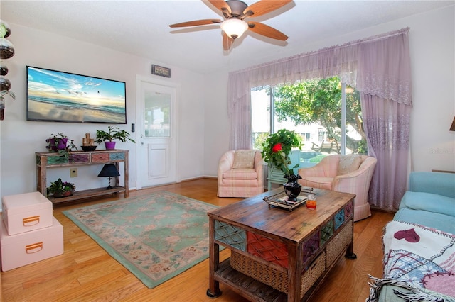 living room with light wood-type flooring and ceiling fan