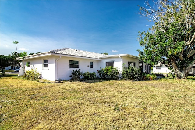 rear view of house with a lawn