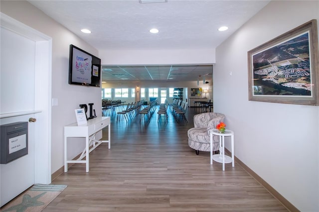 hallway with hardwood / wood-style floors