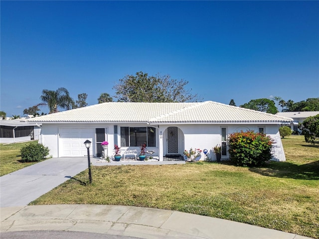 single story home with a garage and a front lawn