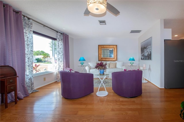 living room with ceiling fan and hardwood / wood-style flooring