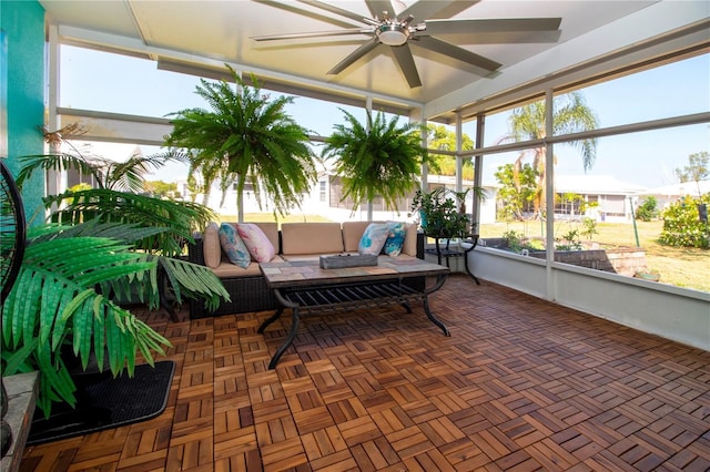 sunroom / solarium featuring ceiling fan