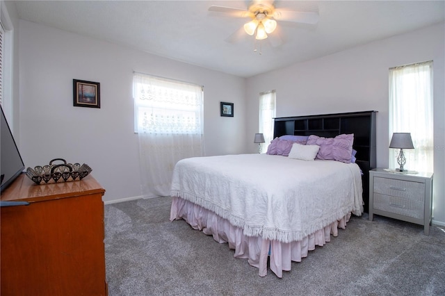 carpeted bedroom featuring multiple windows and ceiling fan