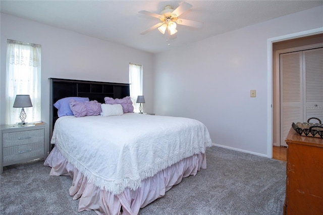 carpeted bedroom with ceiling fan and a closet