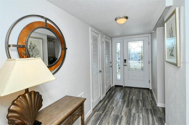 entryway featuring a textured ceiling and dark hardwood / wood-style flooring