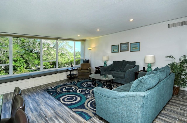 living room featuring hardwood / wood-style floors and crown molding