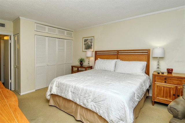 bedroom with crown molding, a textured ceiling, light colored carpet, and multiple closets