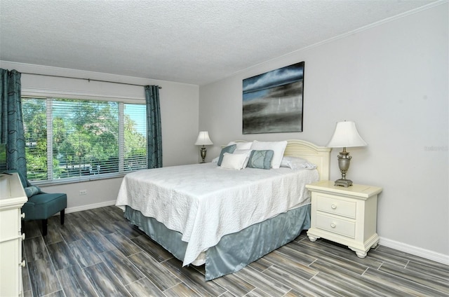 bedroom with a textured ceiling and dark wood-type flooring