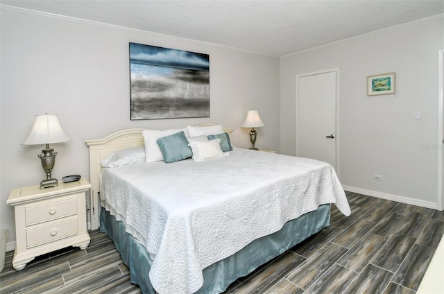 bedroom featuring dark wood-type flooring and a textured ceiling