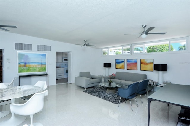 living room with ceiling fan and a textured ceiling