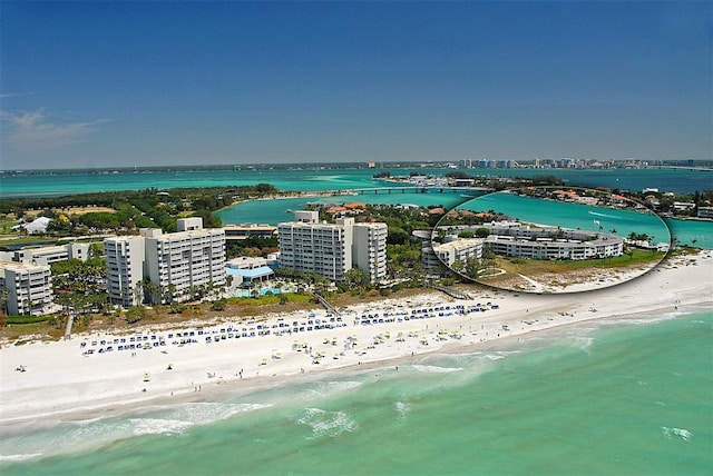 drone / aerial view with a beach view and a water view