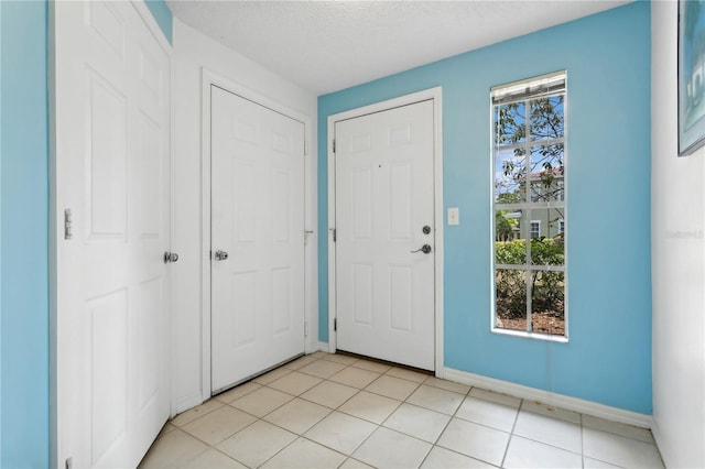 tiled foyer featuring a textured ceiling